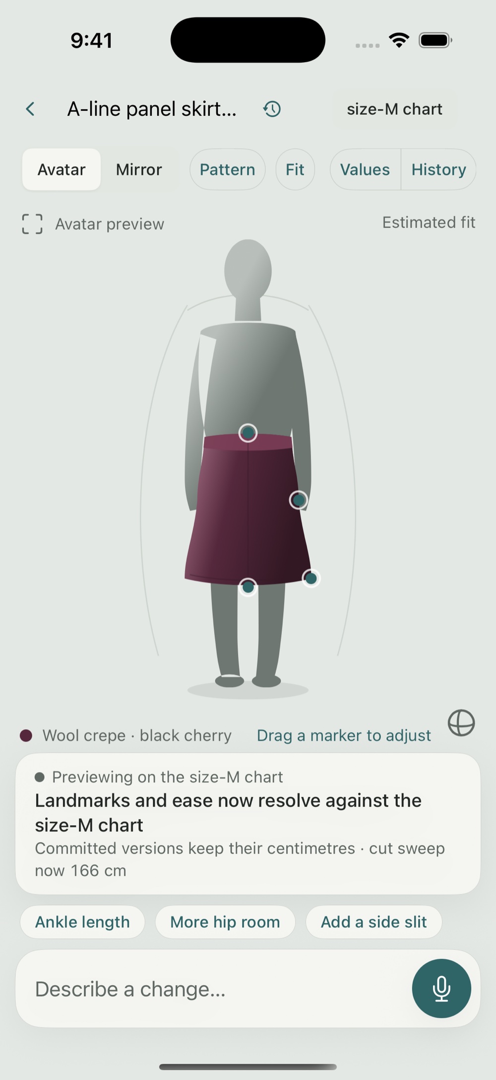 Modeliste fitting view: an A-line panel skirt in wool crepe on an avatar, with draggable adjustment markers and a voice composer reading 'Describe a change'.